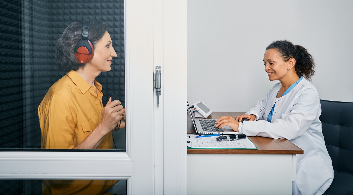 Audiological Exam. Audiologist Doing Hearing Check-up To A Senio