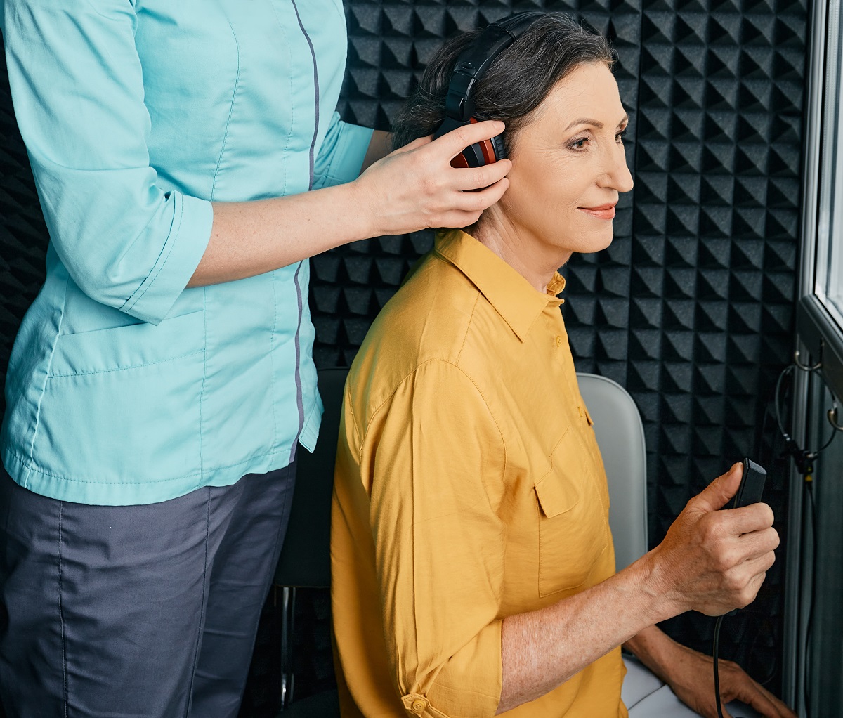 Hearing Test To Mature Woman. Senior Woman During Hearing Test A