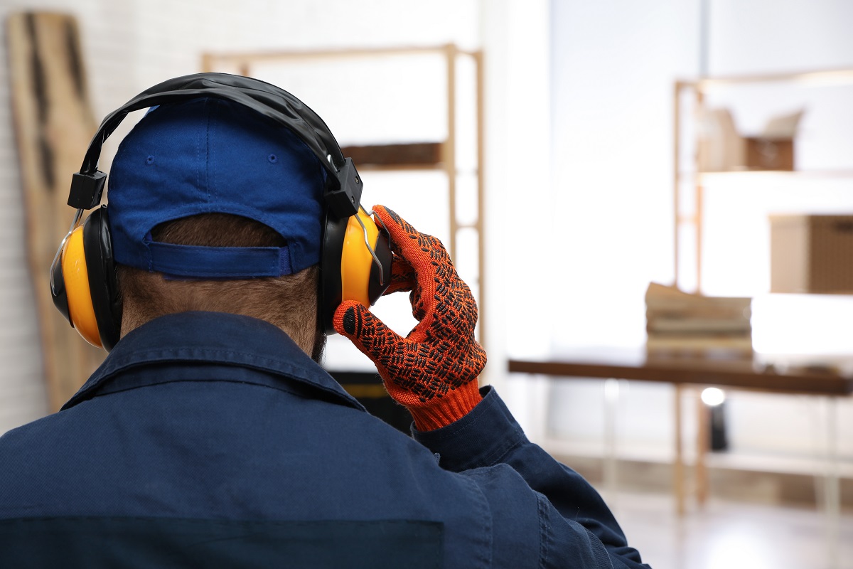 Worker Wearing Safety Headphones Indoors, Back View. Hearing Pro